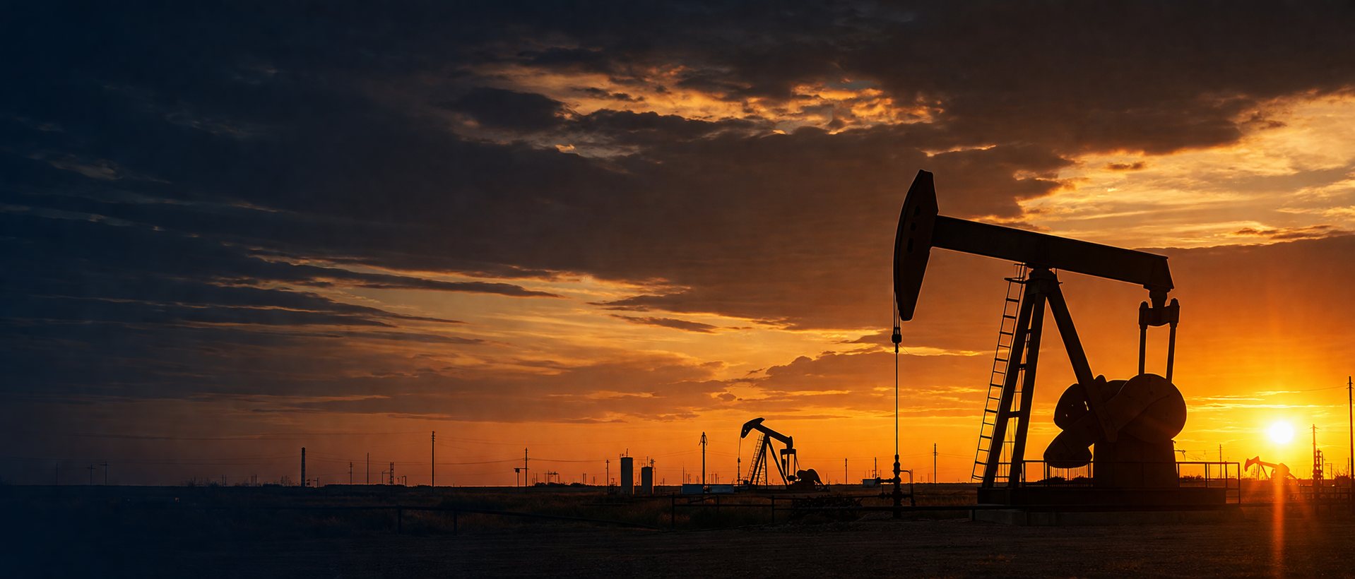 Oil field pump jack at sunset in Texas